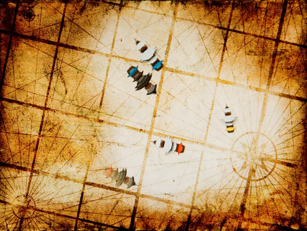 Digital still of the virtual battlefield seen through the tangible lens. Allied ships (white sails) are always visible and opponent ships (black sails) are only visible when in range. The shroud of the fog hides one of the enemy ships.